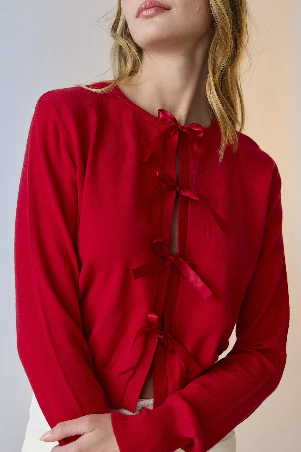 Red knit cardigan with bow detail